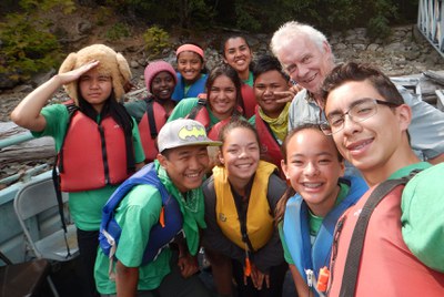 Children and adults in a team canoe on the lake